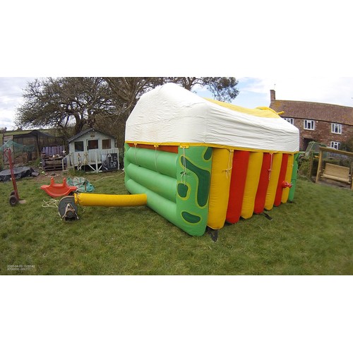 2093 - A 10 x 12ft inflatable bouncy castle (frog) supplied with an inflating blower 240v, a rain cover and... 