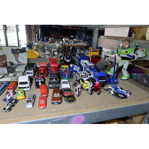 2100 - A quantity of various model cars, toys, a Buzz Lightyear doll etc. Contents of 1 shelf