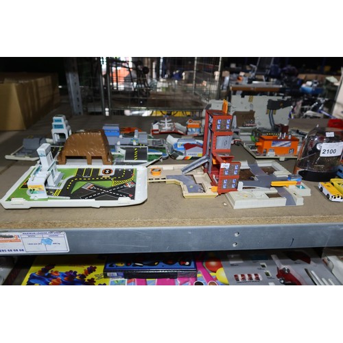 2100 - A quantity of various model cars, toys, a Buzz Lightyear doll etc. Contents of 1 shelf