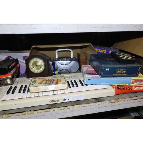 2119 - A quantity of various items including games, a vintage white Yamaha keyboard, a Fiskars rotary fabri... 