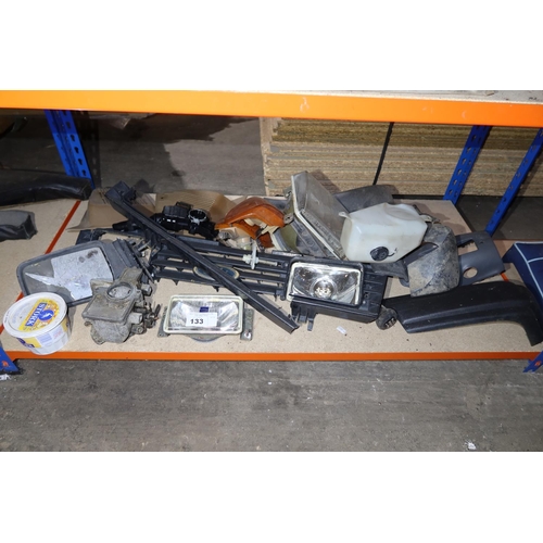 133 - A quantity of various Ford parts including a carburettor, a head light etc. Contents of 1 shelf