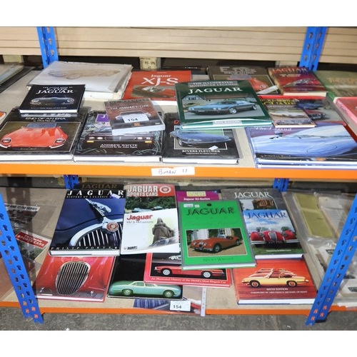 154 - A quantity of various Jaguar books and an E-type DVD. Contents of 2 shelves
