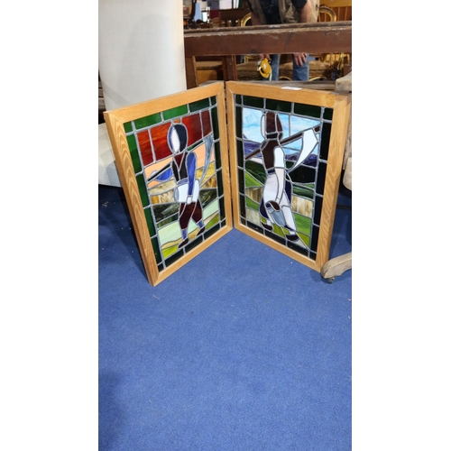 3558 - A light oak framed twofold fire screen with coloured leaded panels