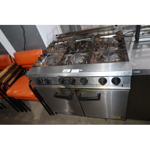 1236 - A commercial stainless steel 6 ring gas fired range with 2 door oven beneath by Falcon - trade