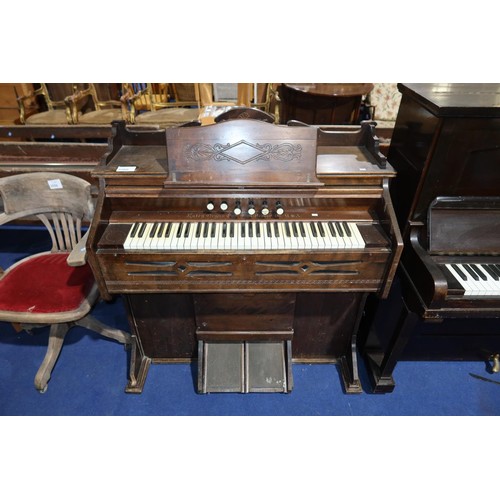 3560 - An Edwardian carved mahogany cased harmonium by the Estey Organ Company