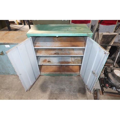 73 - A metal two door storage cabinet