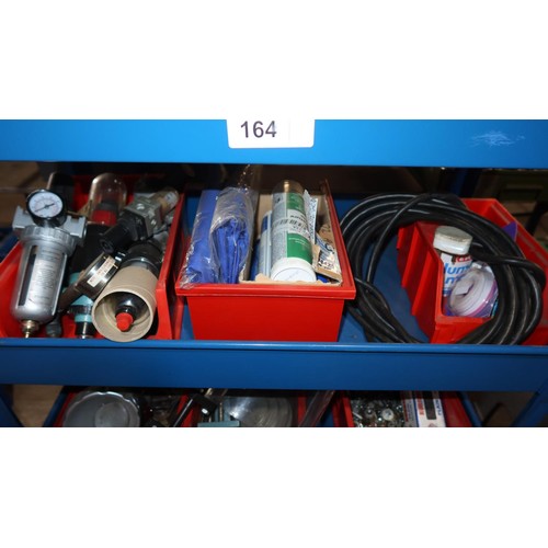 164 - A blue metal workshop trolley with 4 shelves containing a quantity of various engineering related it... 