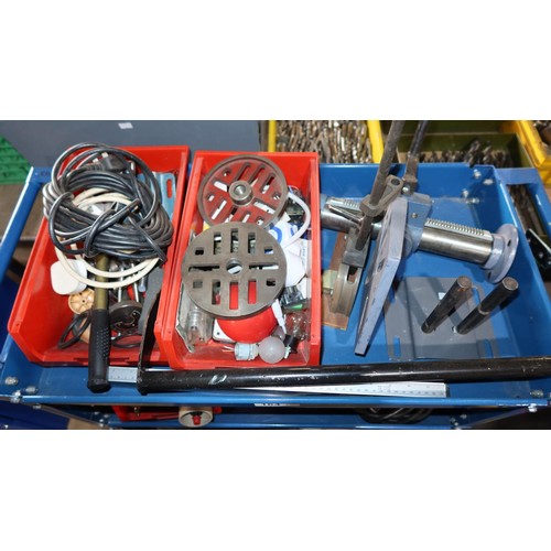 164 - A blue metal workshop trolley with 4 shelves containing a quantity of various engineering related it... 