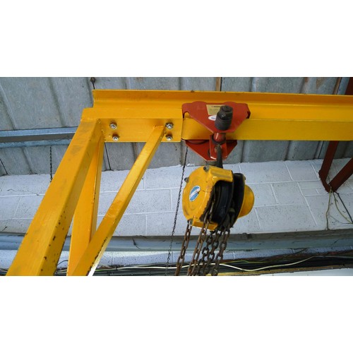 127 - 1 yellow metal portable gantry crane fitted with a travelling cradle and a Davy Morris  500kg chain ... 