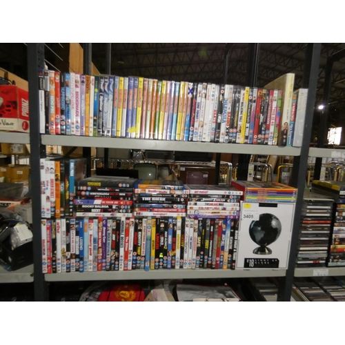 3405 - A quantity of various DVD's & a globe light, contents of 2 shelves - trade