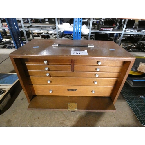 301 - An engineers wooden 7 drawer tool cabinet by Union containing various engineers tools