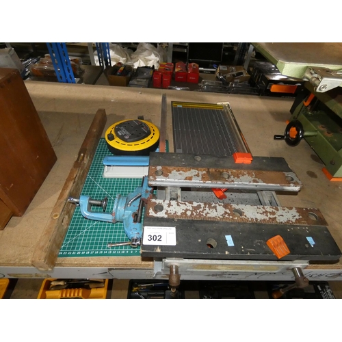 302 - A small clamp to bench swivelling vice (copper jaws), a small bench top clamping / vice unit, 1 pape... 