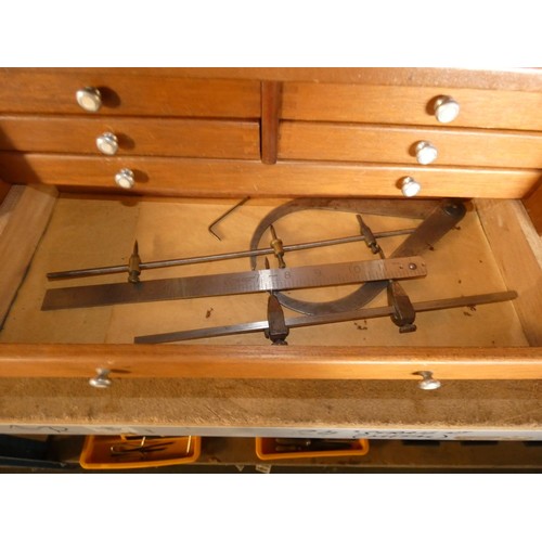 301 - An engineers wooden 7 drawer tool cabinet by Union containing various engineers tools