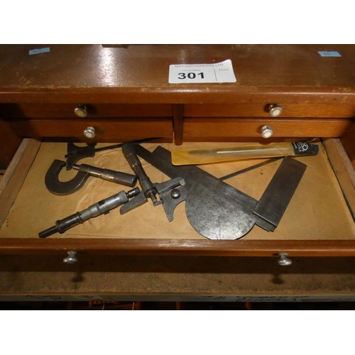 301 - An engineers wooden 7 drawer tool cabinet by Union containing various engineers tools