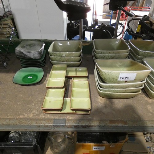 1022 - A quantity of various oriental stoneware crockery mostly green. Contents of one shelf