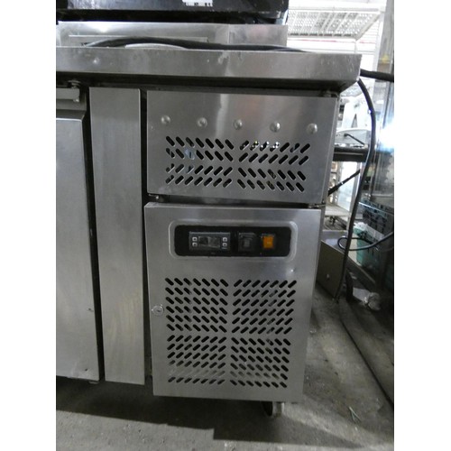 1074 - A commercial stainless steel 3 door bench fridge, no make or model visible