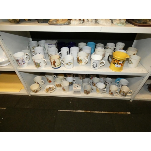 3034 - A collection of royal commemorative mugs and similar china (two shelves)