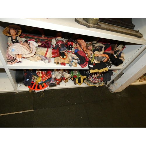 3045 - A collection of miscellaneous souvenir dolls (2 shelves)