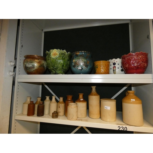 3048 - A quantity of decorative jardiniers and a quantity of vintage stoneware jars (two shelves)