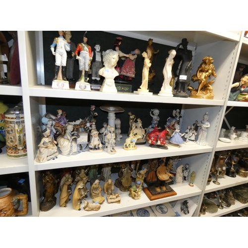 3057 - A large quantity of miscellaneous decorative resin and ceramic figures (three shelves)