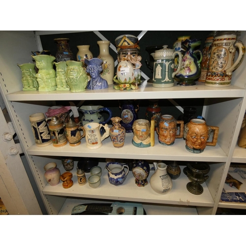 3061 - A quantity of miscellaneous decorative beer steins, Toby & character jugs and vases etc (three shelv... 