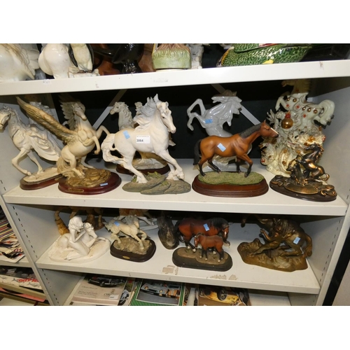 3064 - A quantity of miscellaneous decorative resin, ceramic and other horse ornaments (two shelves)