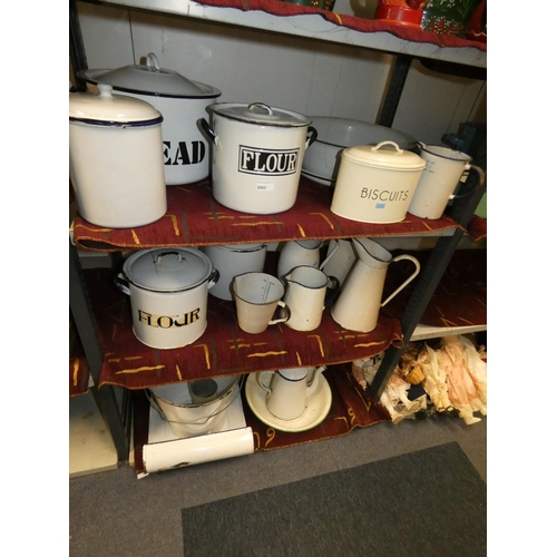 3083 - A quantity of vintage white and cream enamelled kitchen ware including; bread bins, flour bins, jugs... 