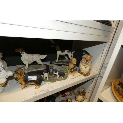 3030 - A collection of resin and ceramic dogs (three shelves)