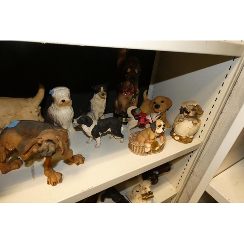 3030 - A collection of resin and ceramic dogs (three shelves)