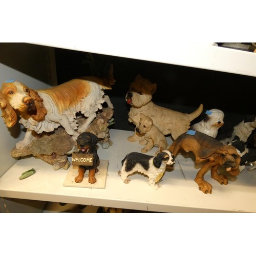 3030 - A collection of resin and ceramic dogs (three shelves)