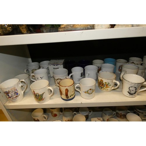 3034 - A collection of royal commemorative mugs and similar china (two shelves)