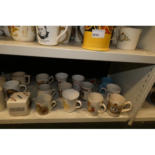 3034 - A collection of royal commemorative mugs and similar china (two shelves)