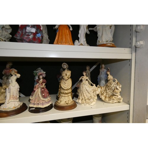 3037 - A collection of miscellaneous resin and ceramic decorative figures of ladies (2 shelves)