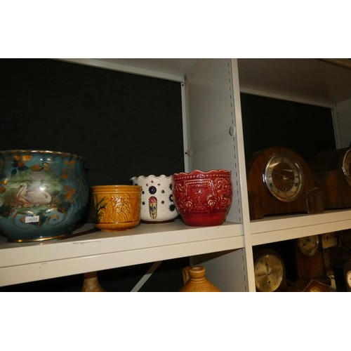 3048 - A quantity of decorative jardiniers and a quantity of vintage stoneware jars (two shelves)