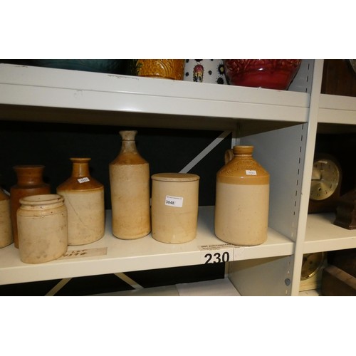 3048 - A quantity of decorative jardiniers and a quantity of vintage stoneware jars (two shelves)