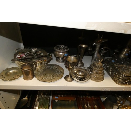 3055 - A large quantity of miscellaneous decorative silver-plated ware and cutlery (4 shelves)