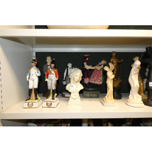 3057 - A large quantity of miscellaneous decorative resin and ceramic figures (three shelves)