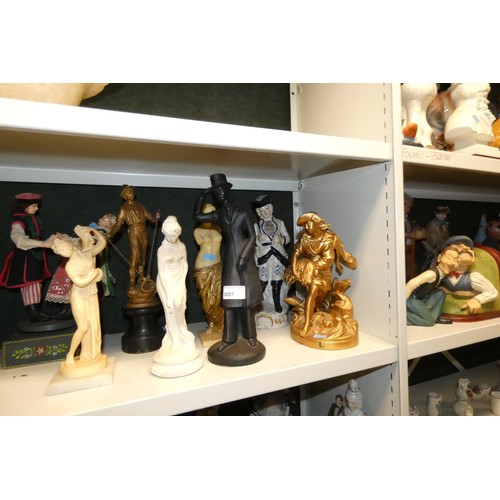 3057 - A large quantity of miscellaneous decorative resin and ceramic figures (three shelves)