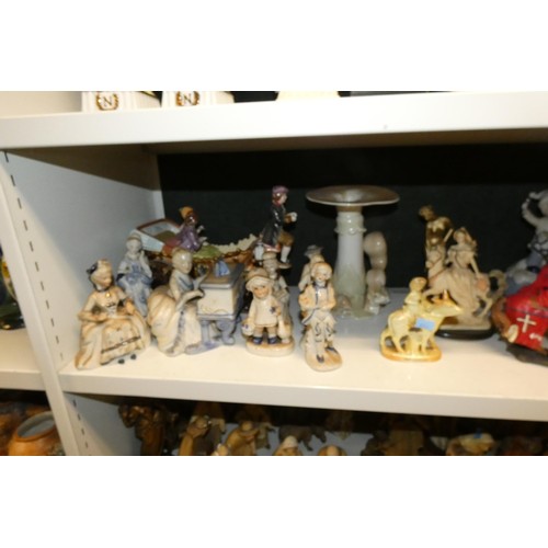 3057 - A large quantity of miscellaneous decorative resin and ceramic figures (three shelves)