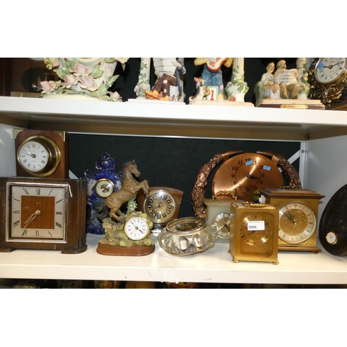 3060 - A quantity of miscellaneous decorative resin, ceramic, wooden cased and other clocks (2 shelves)