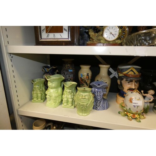 3061 - A quantity of miscellaneous decorative beer steins, Toby & character jugs and vases etc (three shelv... 