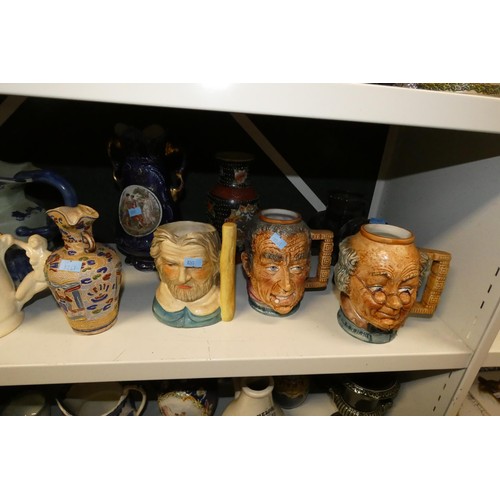 3061 - A quantity of miscellaneous decorative beer steins, Toby & character jugs and vases etc (three shelv... 