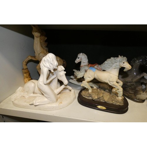 3064 - A quantity of miscellaneous decorative resin, ceramic and other horse ornaments (two shelves)