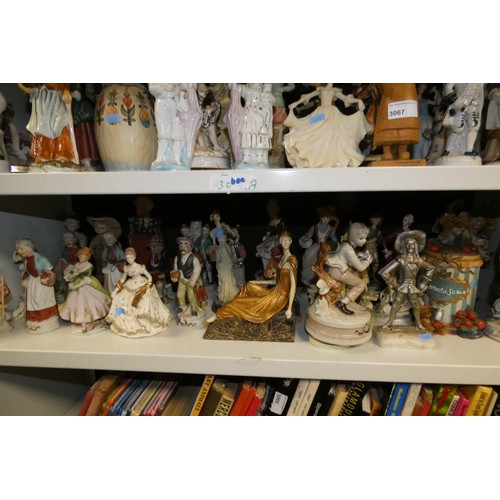 3067 - A quantity of miscellaneous decorative resin, ceramic and other figures (2 shelves)