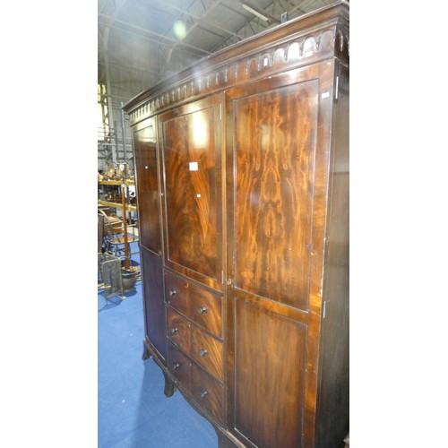 3491 - Mahogany bow front wardrobe with three panel doors & three drawers, approximately 156cm wide.  The t... 