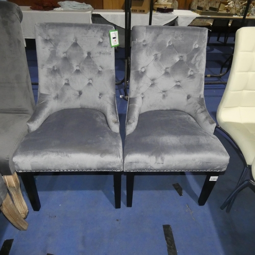 1385 - 2 grey upholstered button back dining chairs each with metal stud decoration and a rear ring handle