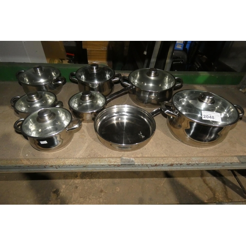 2048 - A quantity of various stainless steel pots and pans with glass lids