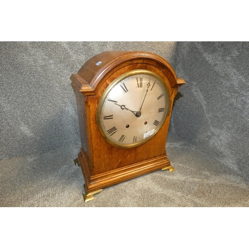 4226 - An Edwardian Oak cased domed top bracket clock with a brass mounted face and chiming movement