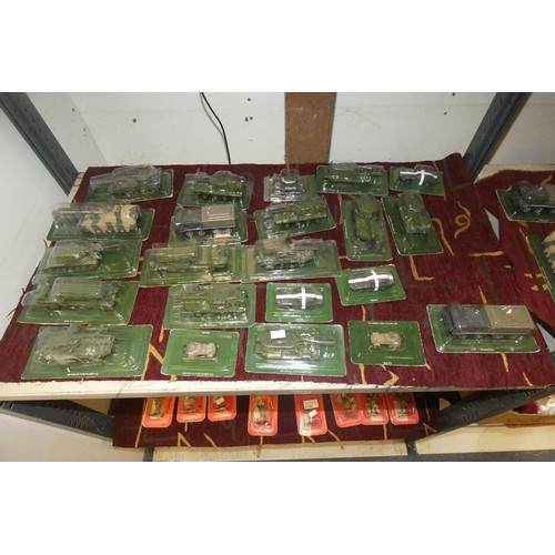4129 - A collection of boxed miniature model military vehicles (two shelves)