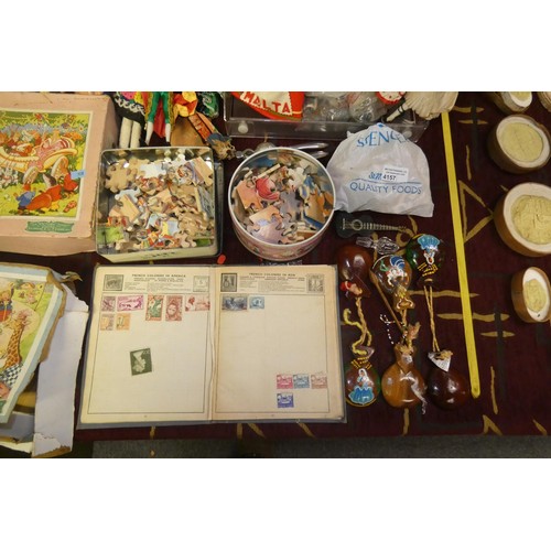 4157 - A collection of miscellaneous souvenir dolls, vintage jigsaws, stamps and other trinkets